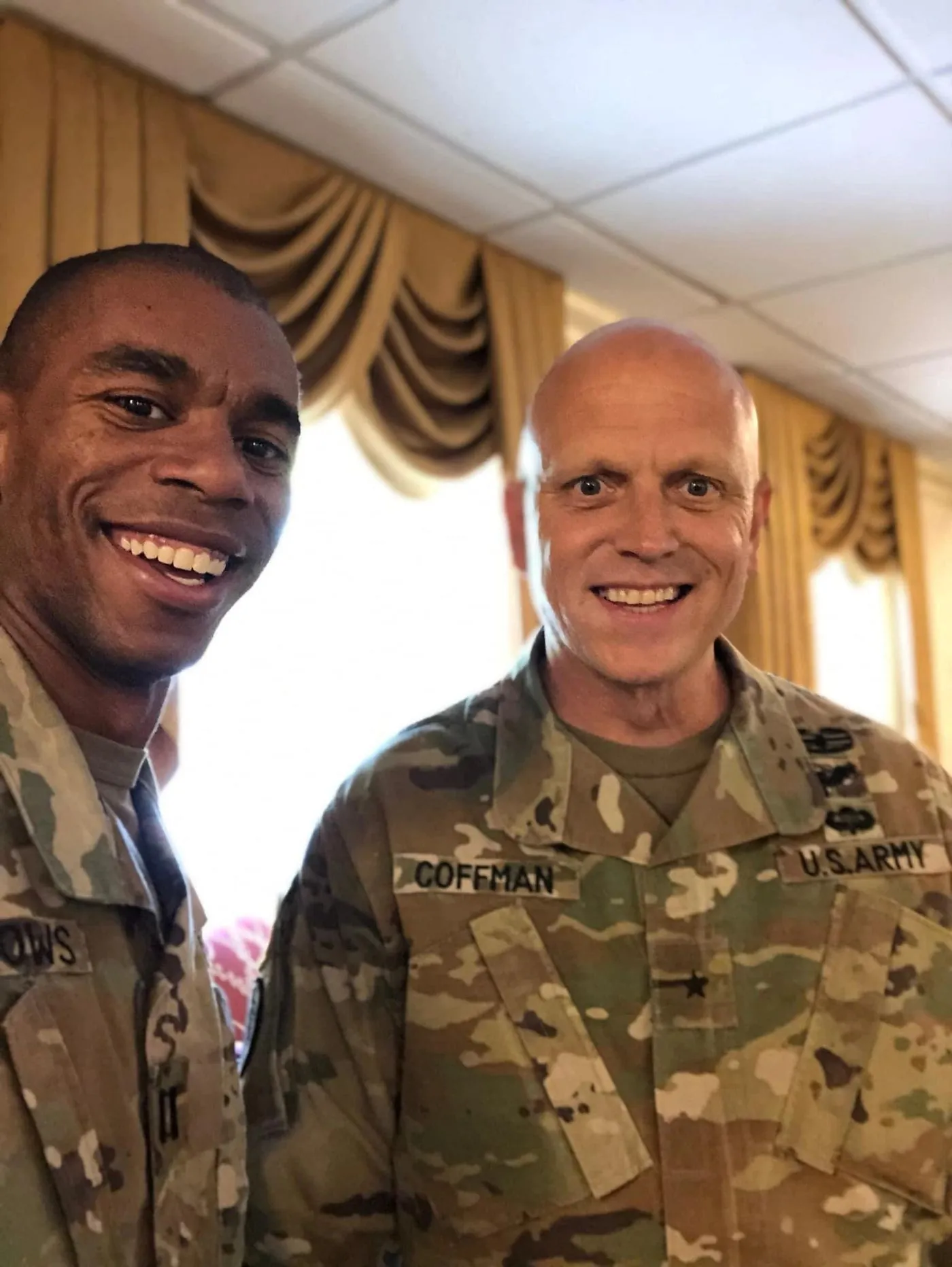 Coffman in Army camo uniform alongside a fellow soldier